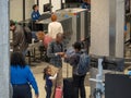 Family gathering belongings after passing through a Transportation Security Administration (TSA) checkpoint at JFK Airport.